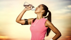 sporty girl drinking water